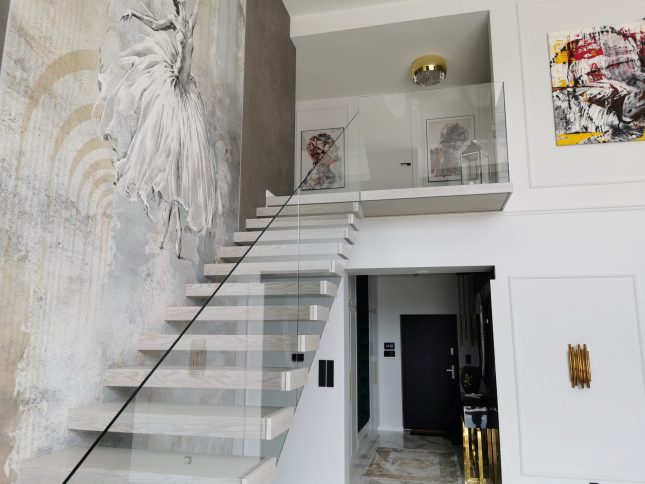 Schody półkowe z balustradą szklaną